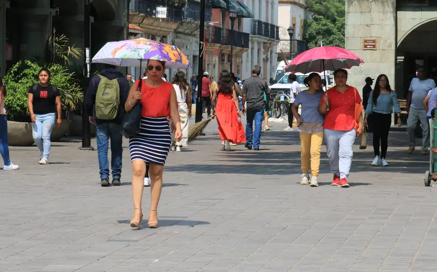 personas-caminando-sombrilla-calor