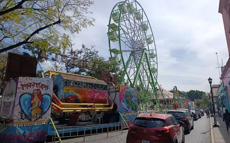 Juegos mecánicos instalados sobre un carril de la Avenida Juárez como parte de la verbena en el Parque Juárez El Llano.