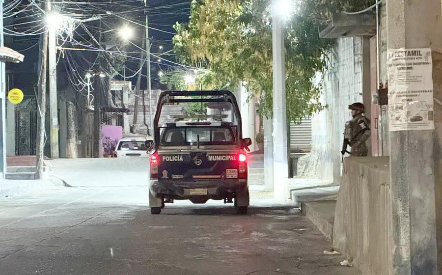 Elementos de la Policía Municipal retiran la manta que apareció en el barrio Laborío de Tehuantepec.