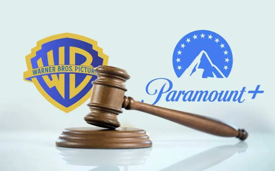 Logotipos de Paramount y Warner Bros. que ilustran la megafusión de Hollywood, ahora pausada por la justicia en un acuerdo millonario.