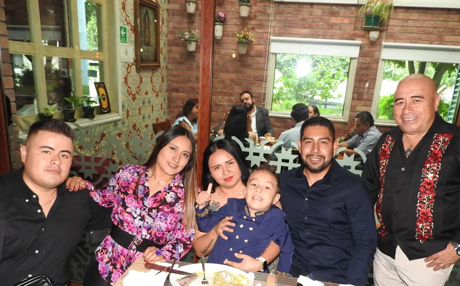 Matías Edalí Montero González celebra su graduación de preescolar, posando felizmente con sus padres, padrinos y su abuelito durante el festejo familiar.