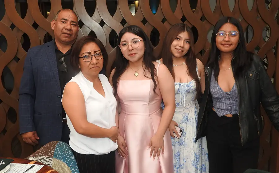 Astrid Montiel celebra la culminación de sus estudios medios superiores, posando sonriente junto a sus padres, su hermana Vania y su mejor amiga Ximena.
