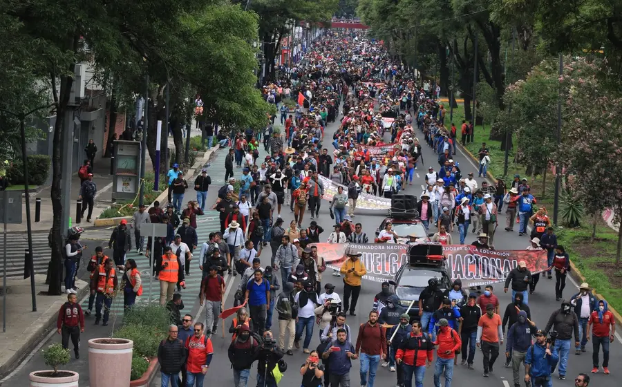 Manifestantes de organizaciones sociales levantan pancartas en una calle durante las protestas por la apertura del Mundial de fútbol.