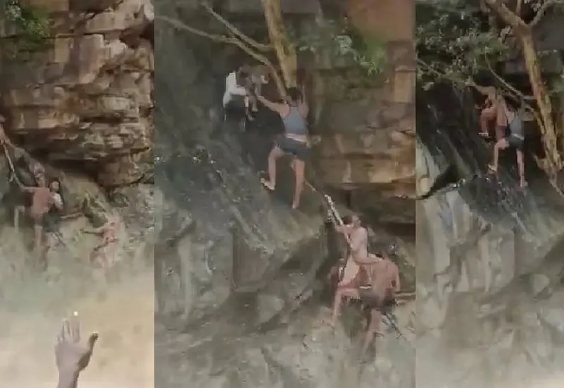 La secuencia muestra a dos personas quienes pierden el equilibrio y caen al agua embravecida.