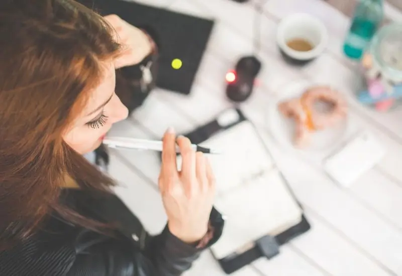 Mujer pensando sobre el escritorio