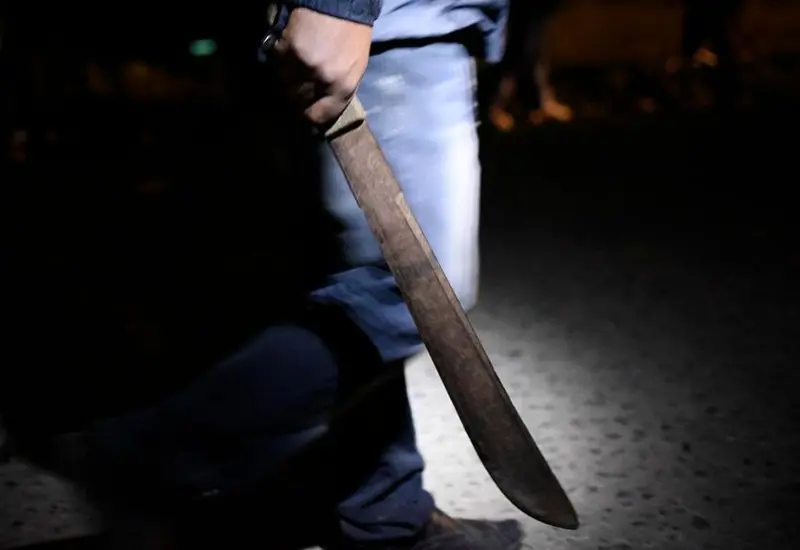 Persona sujetando un machete