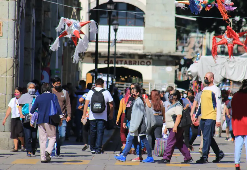 Gente con cubrebocas caminando.