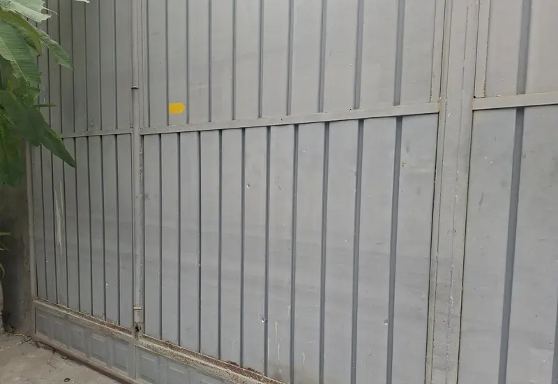 Un portón de metal muestra múltiples impactos de bala tras un ataque armado a una vivienda particular en Juchitán, Oaxaca.