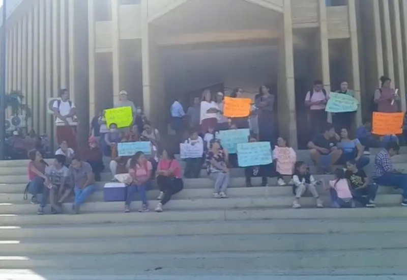 Padres de familia y docentes protestan frente al Palacio Municipal de Salina Cruz para exigir seguridad y luz eléctrica en su escuela.