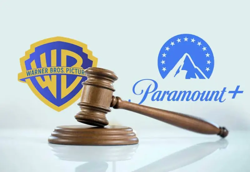 Logotipos de Paramount y Warner Bros. que ilustran la megafusión de Hollywood, ahora pausada por la justicia en un acuerdo millonario.