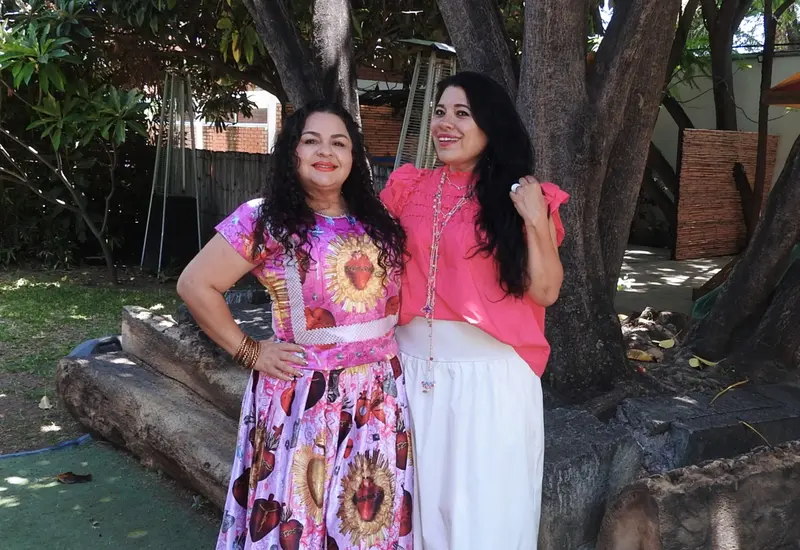 Nayeli Cuevas y Georgina Meneses sonríen para la foto mientras disfrutan de una agradable plática y un café en un evento social.